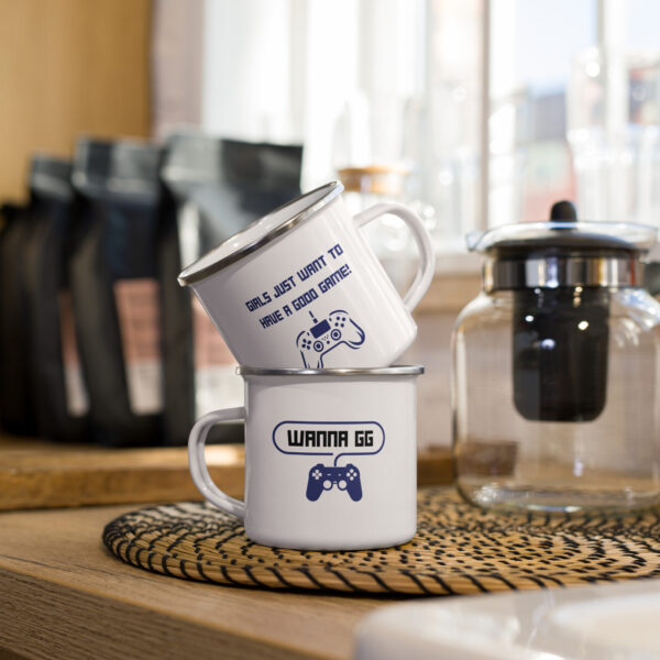 2 cups of the same design, stacked, showing both sides of the cup. First side: "girls just want to have a good game!" in blue with a blue PlayStation controller underneath Second side: "wanna gg" in black with a blue PlayStation controller