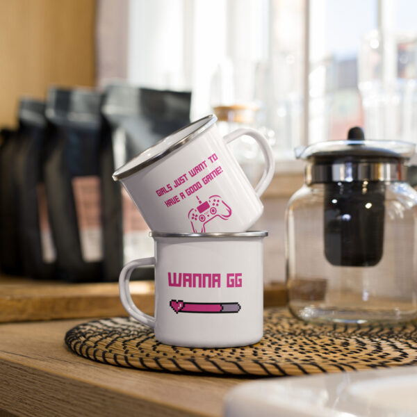 2 cups of the same design, stacked, showing both sides of the cup. First side: "girls just want to have a good game!" in pink with a pink PlayStation controller underneath Second side: "wanna gg" in pink with a pink lifebar underneath