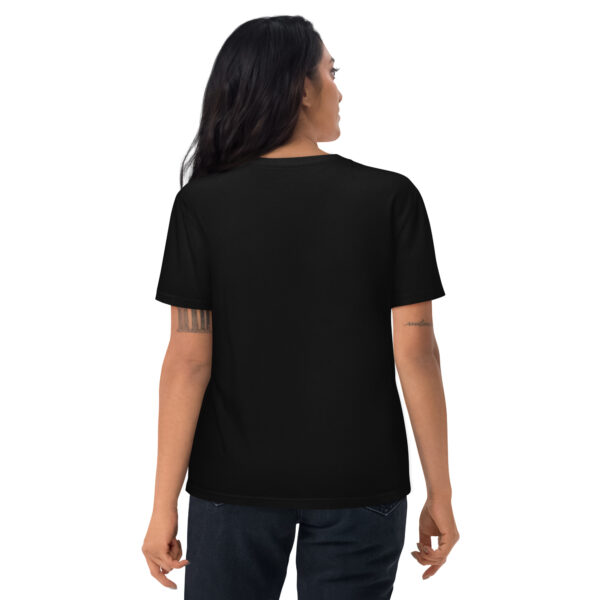 A woman posing from behind wearing a black tshirt with no pattern