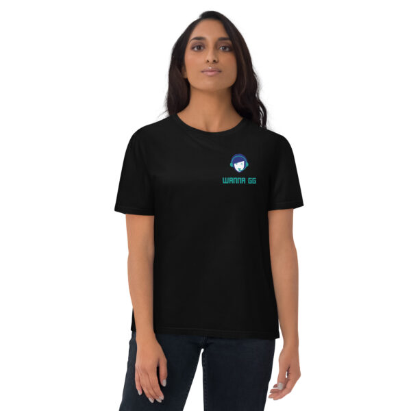 A woman posing head-on wearing a black tshirt on which is written "wanna gg" underneath our website logo