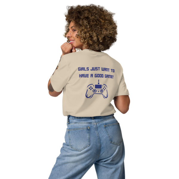 A woman posing from behind wearing a beige tshirt on which is written "girls just want to have a good game!" in blue with a blue PlayStation controller underneath