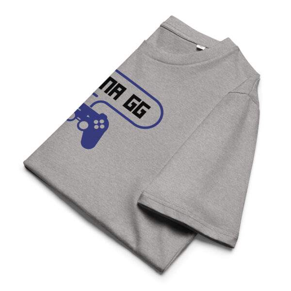 A grey folded tshirt on which is written "wanna gg" in black with a blue PlayStation controller