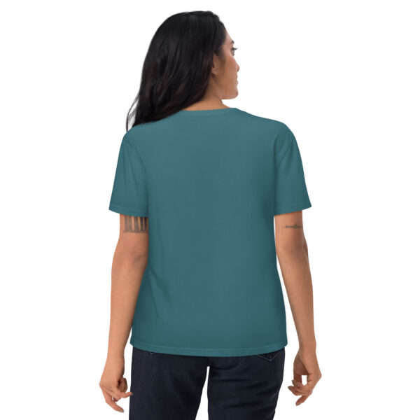 A woman posing from behind wearing a green/blue tshirt with no pattern