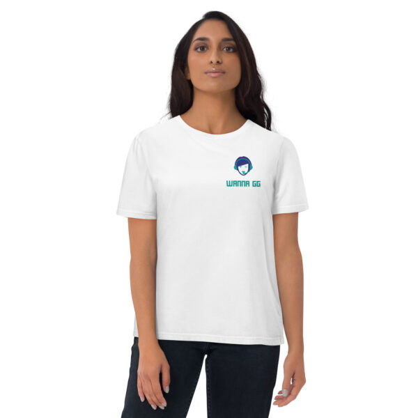 A woman posing head-on wearing a white tshirt on which is written "wanna gg" underneath our website logo