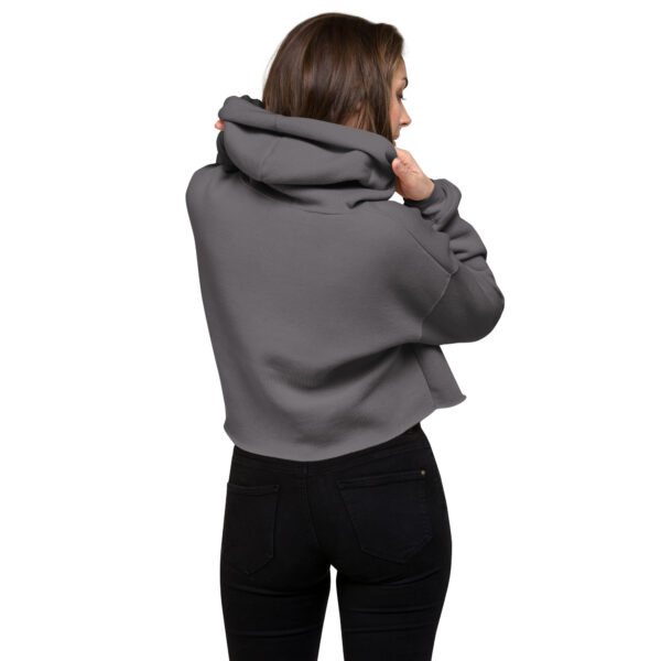 A woman posing from behind wearing a grey sweatshirt with no pattern on the back