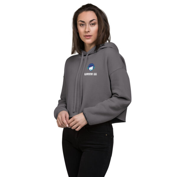 A woman poses head-on wearing a grey sweatshirt and it says "wanna gg" in white underneath our website logo