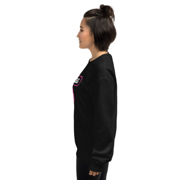 A woman poses sideway wearing a black sweater and it says "wanna gg" in white with a pink PlayStation controller